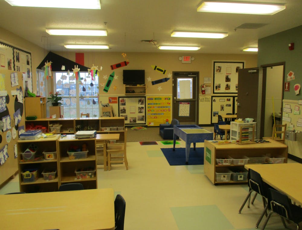 Classroom with child-sized furniture, tables, and learning decorations