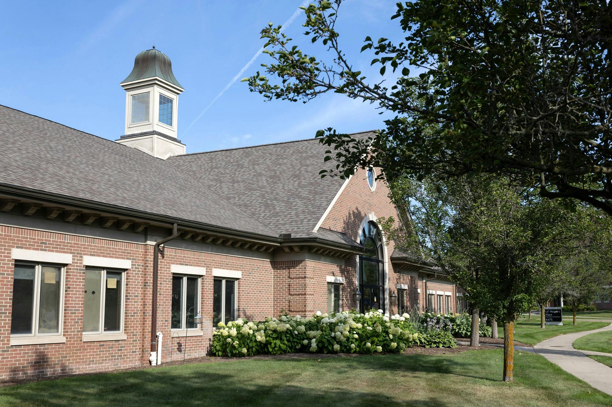 Brick building with a cupola and landscaping