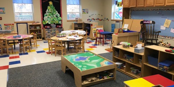 Empty classroom with small tables and chairs