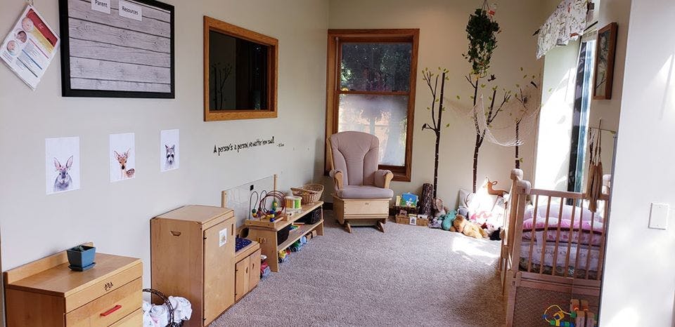 Nursery room with a crib, rocking chair, and wooden furniture