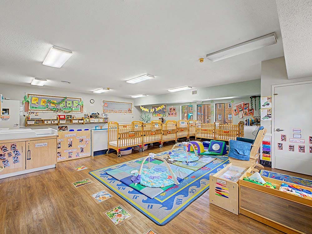 Cribs and playmats in a daycare classroom