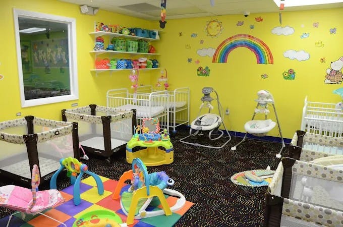 Nursery room with cribs, playpens, and baby swings