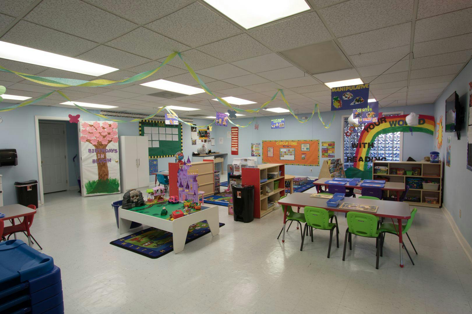Classroom with tables, chairs, and play areas