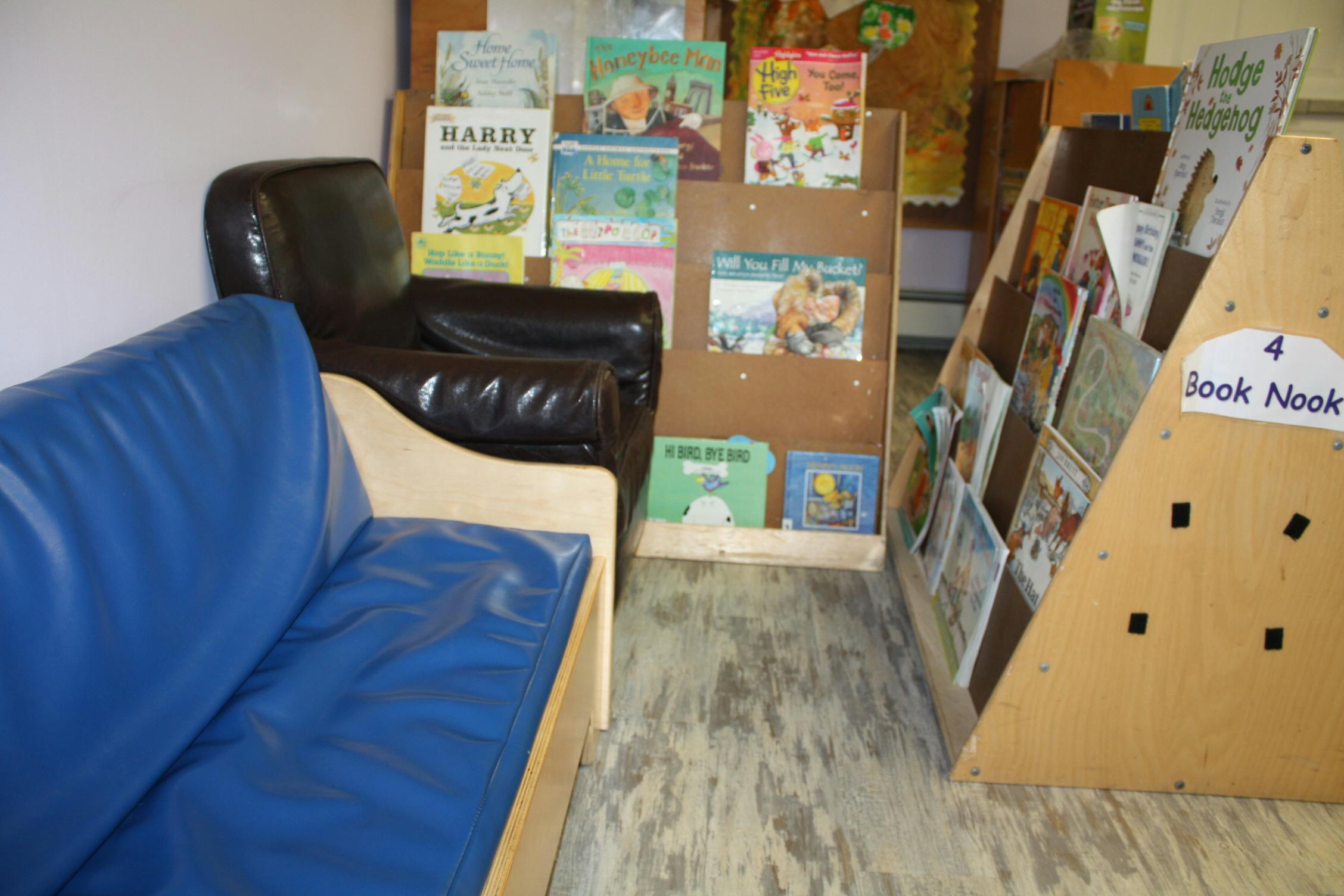 Book nook with a blue couch and a brown armchair