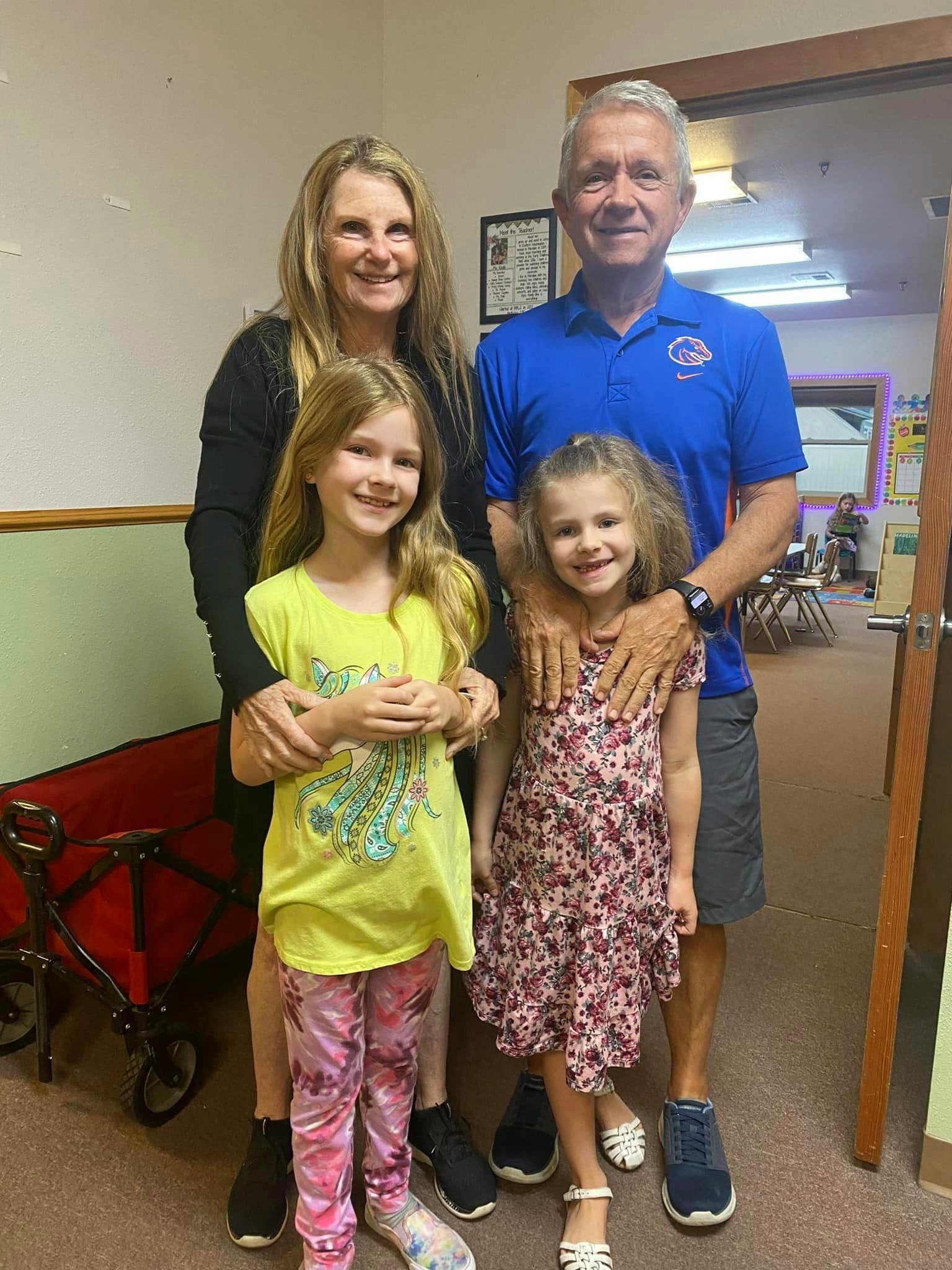 Two adults and two children posing for a photo