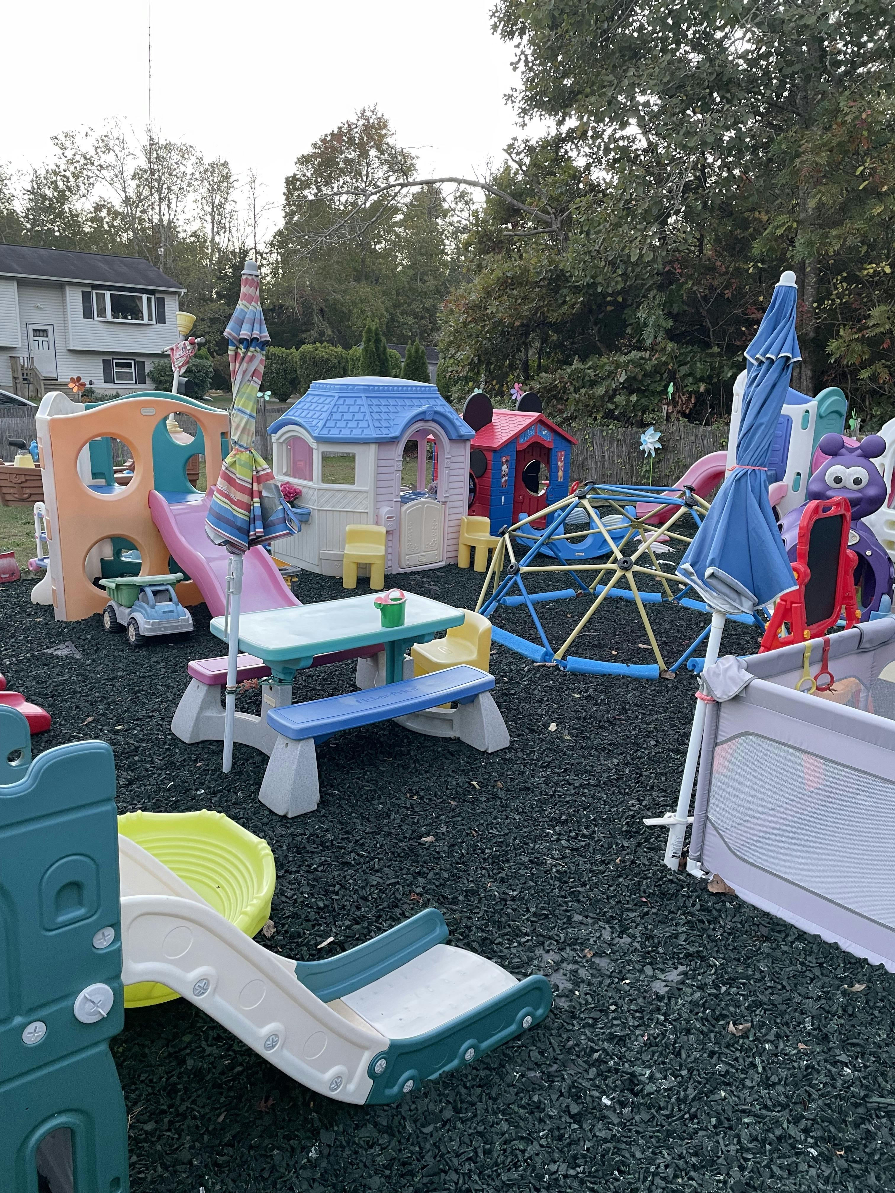 Outdoor playground with slides, playhouses, and climbing dome