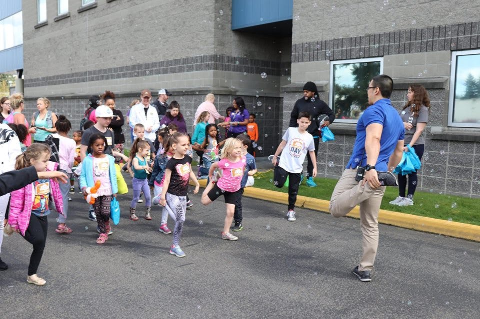 Adults and children walking and stretching outdoors