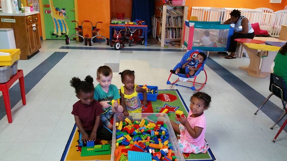 Children playing with building blocks in a room