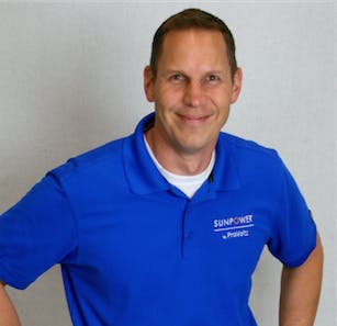 Person in a blue polo shirt with a logo