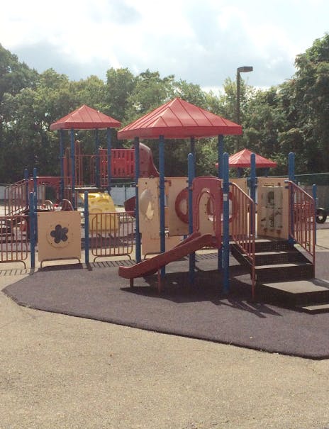 Playground with red roofs, slides, and stairs