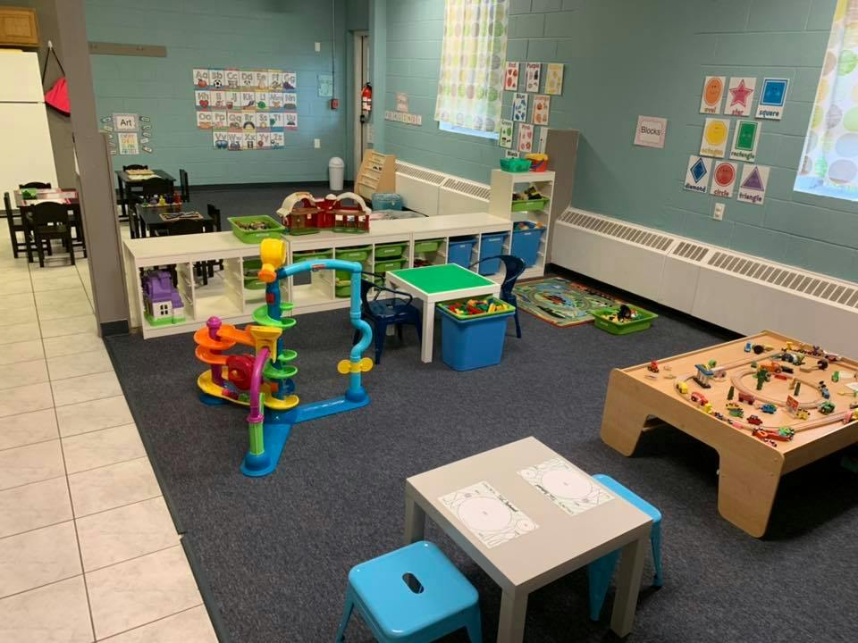 Playroom with various toys, tables, and chairs