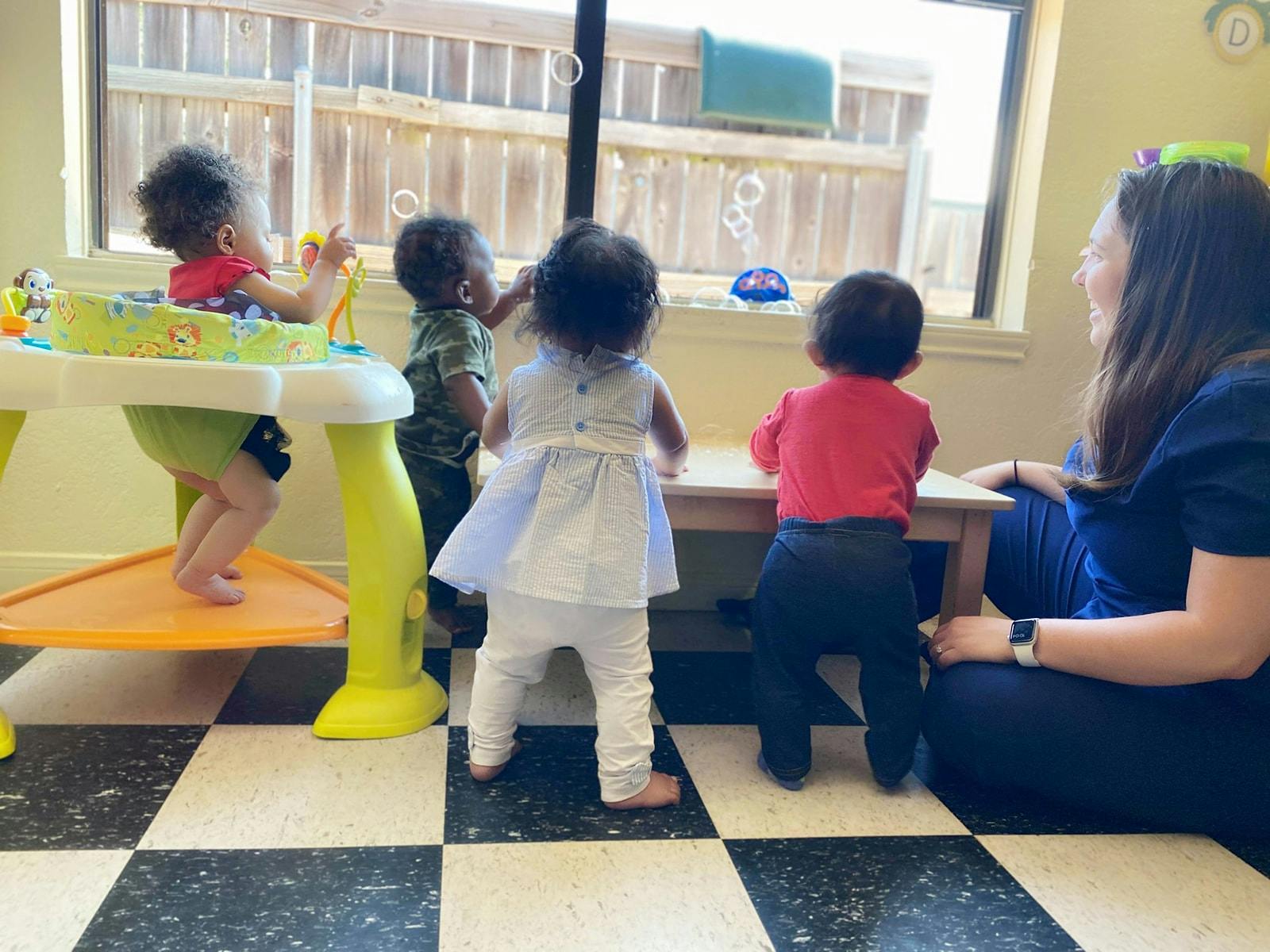 Adult and multiple children in a classroom