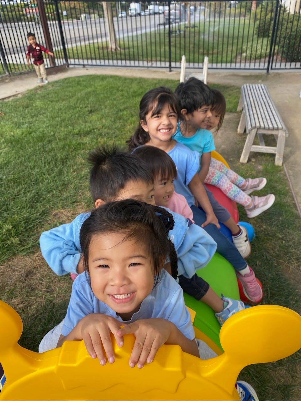 Group of children playing on a colorful seesaw