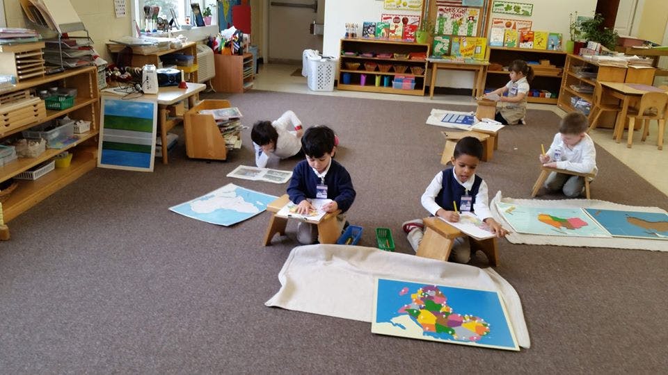 Children working on individual activities in a classroom