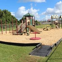 Empty playground with slides, swings, and sand