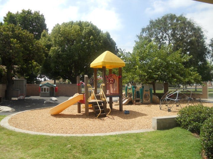 Playground with yellow slide and climbing structure