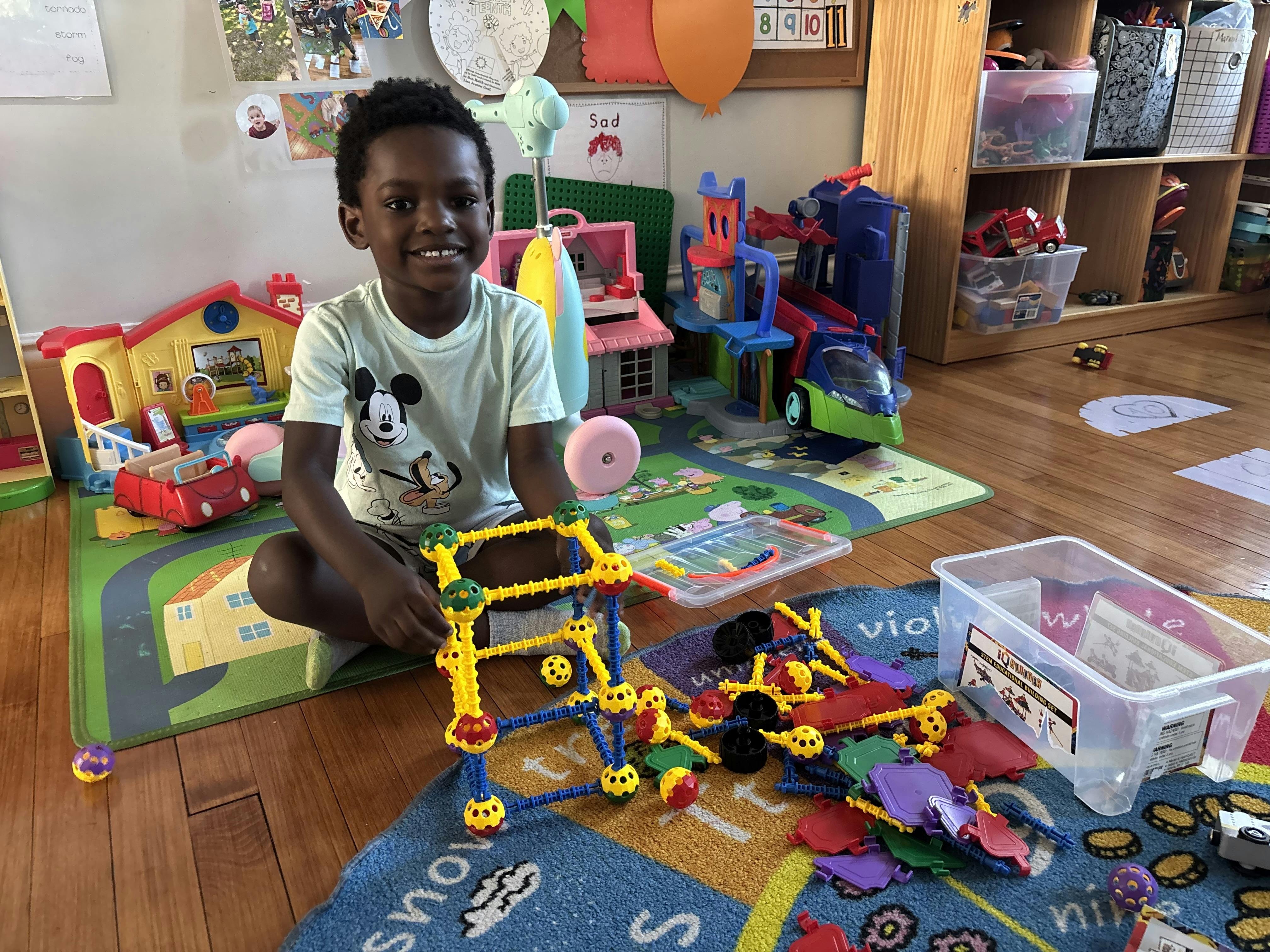 Child sitting on floor with building toys