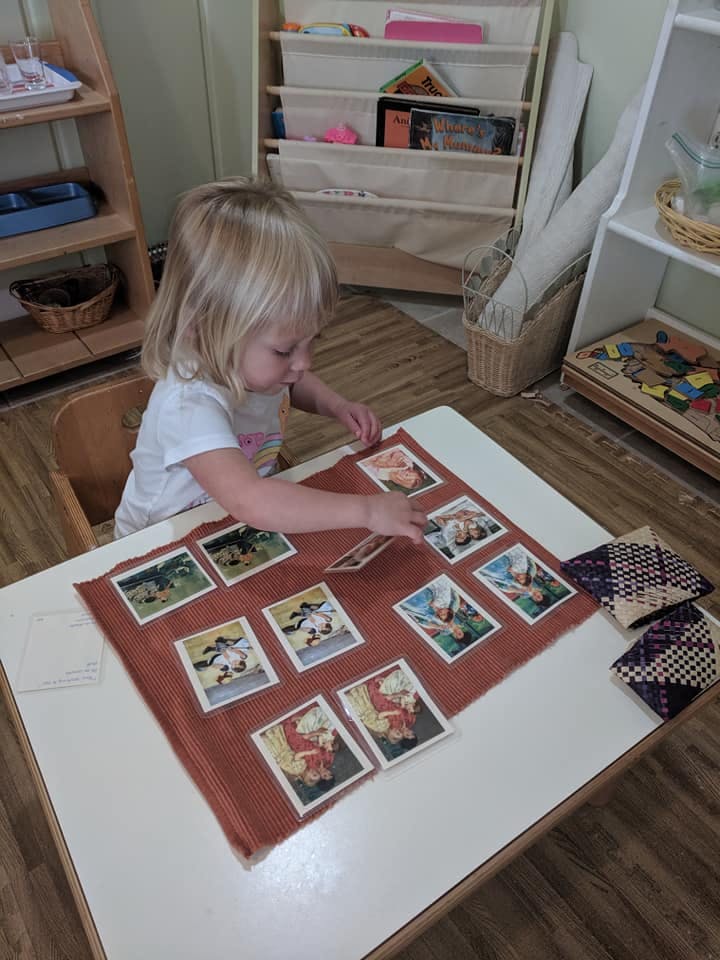 Child sorting picture cards on a table