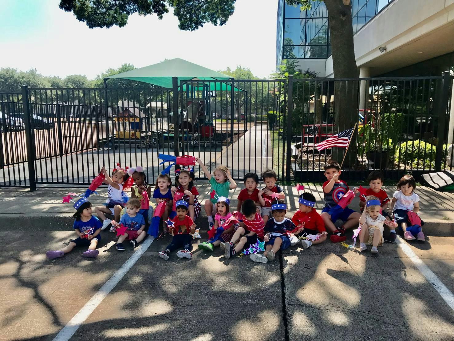 Group of children sitting on the ground outdoors
