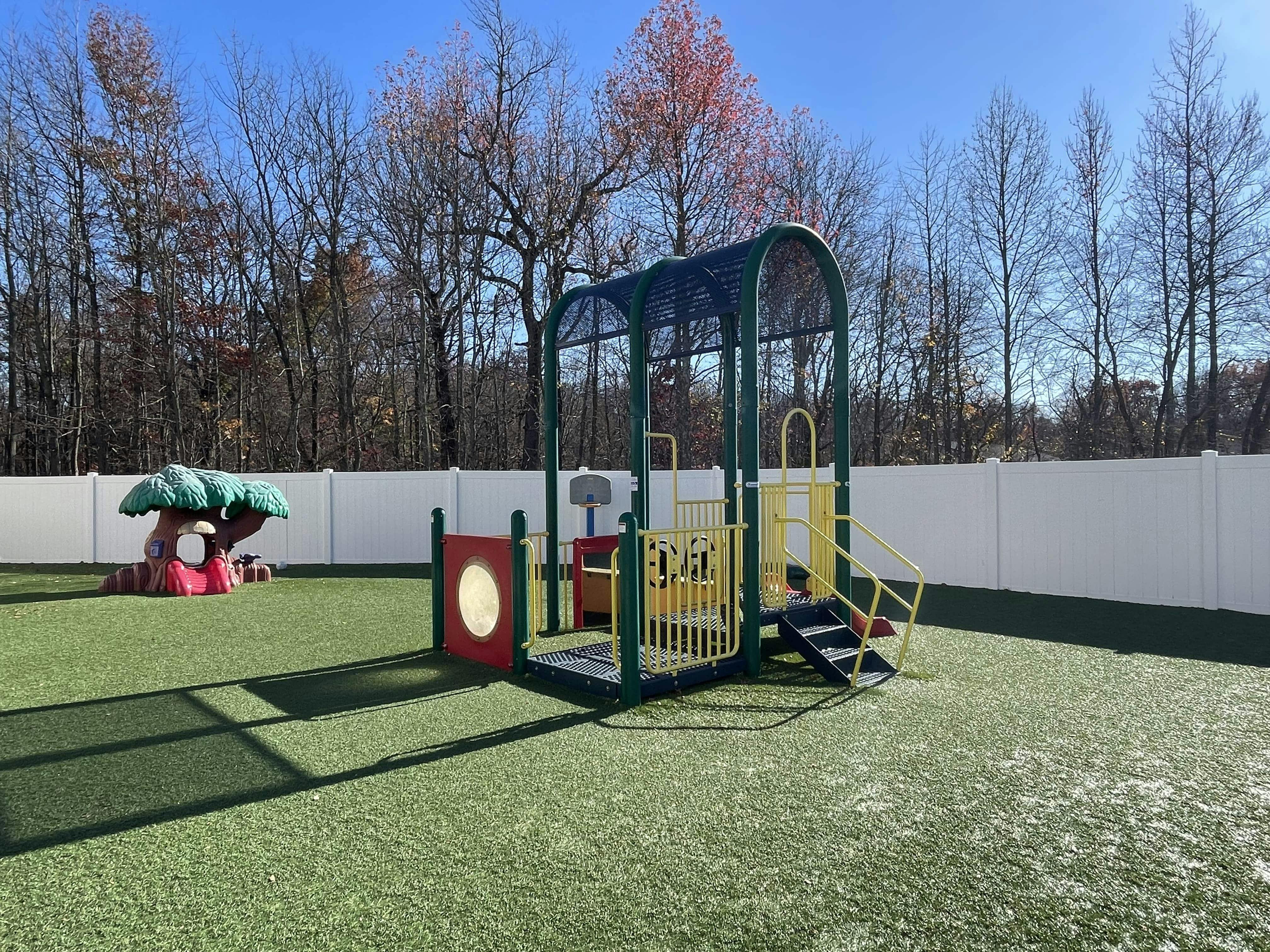 Playground with a climbing structure and a mushroom-shaped play object