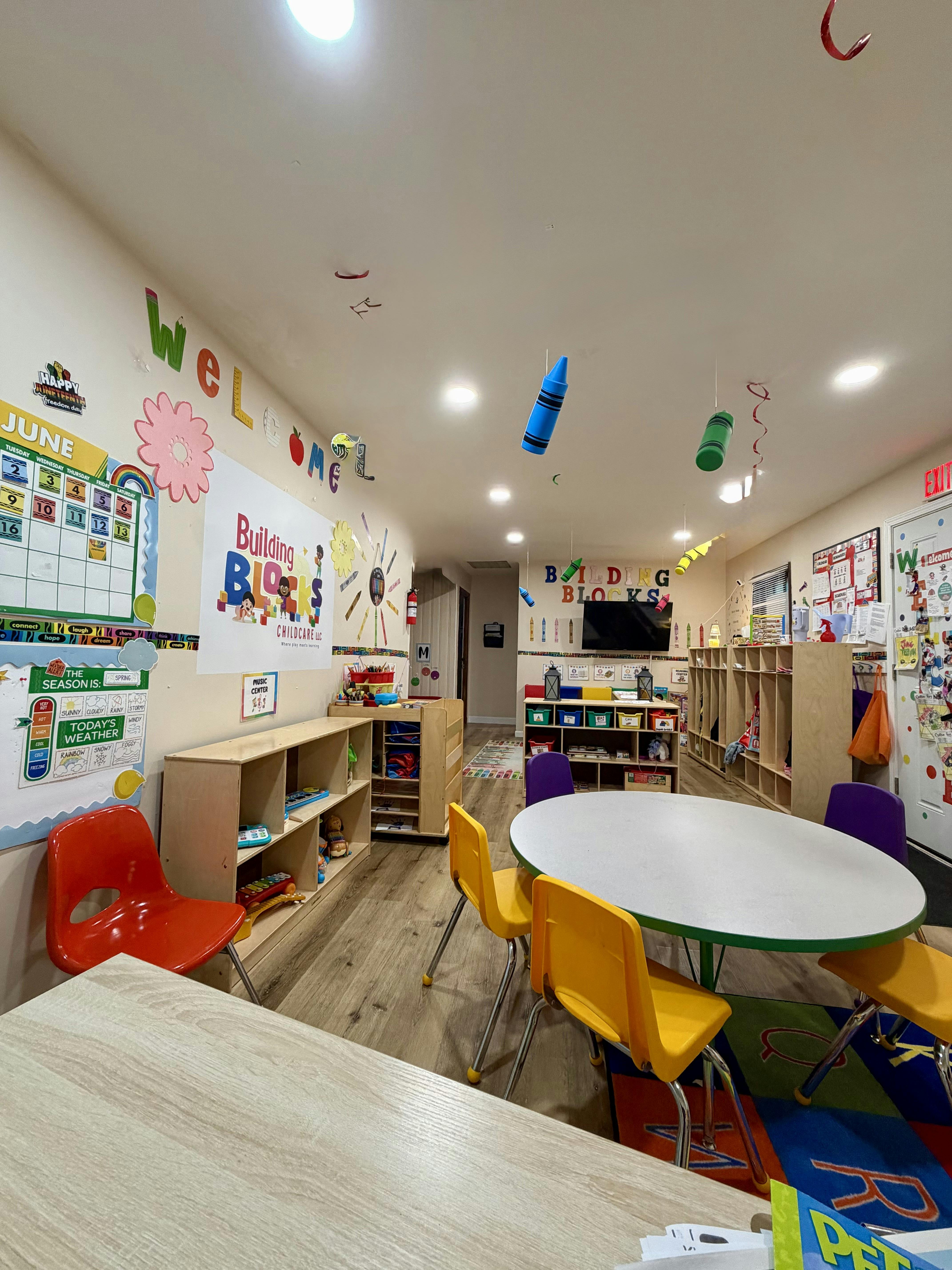 Colorful classroom interior with tables, chairs, and learning decorations