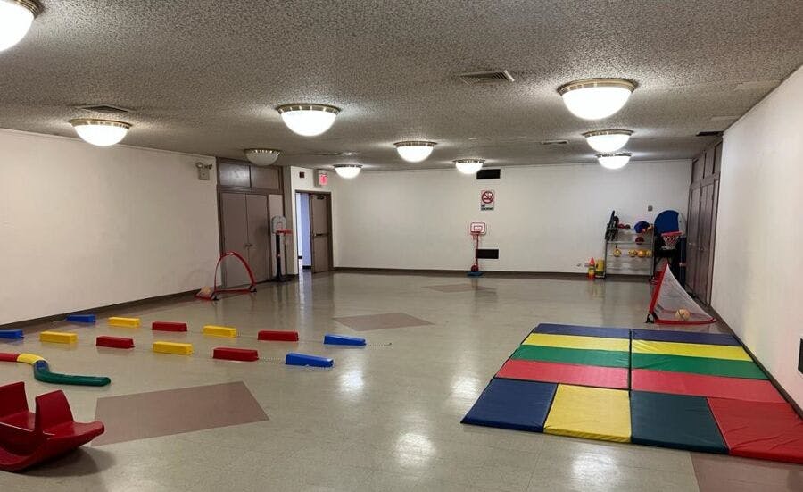 Empty room with colorful play mats and blocks on the floor