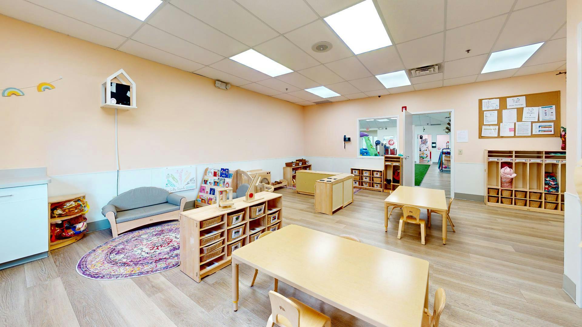 Empty classroom with small tables and chairs