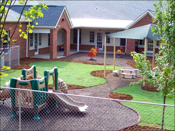 Outdoor playground with play structure, slide, and covered picnic area