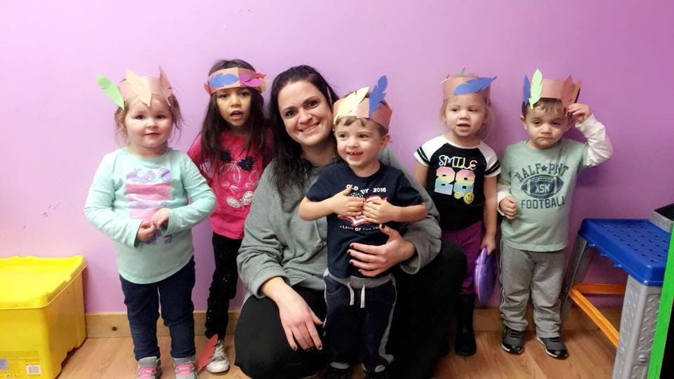 Adult and five children wearing paper crowns