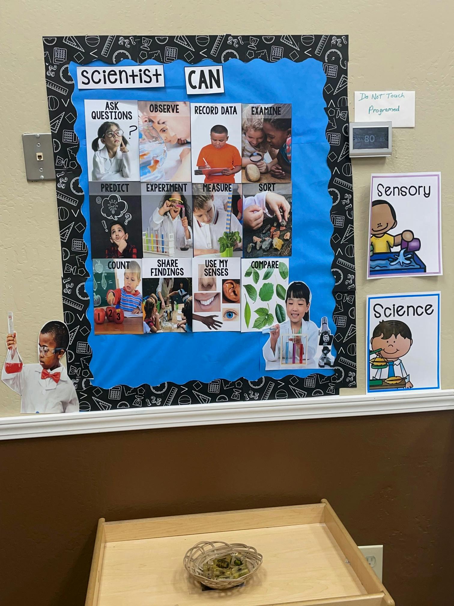 Bulletin board with "Scientist Can" and photos of children doing science activities