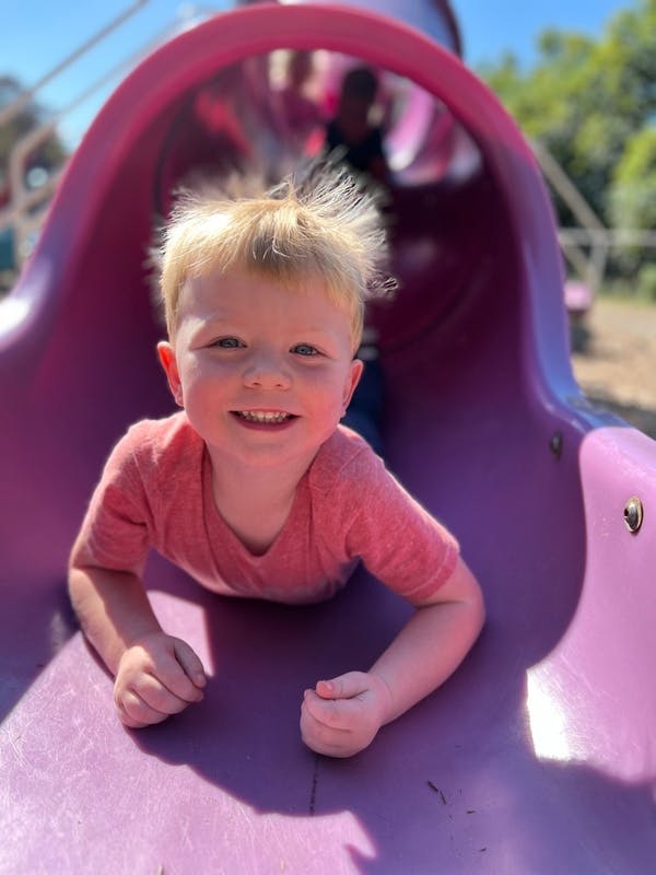 Child on a purple slide