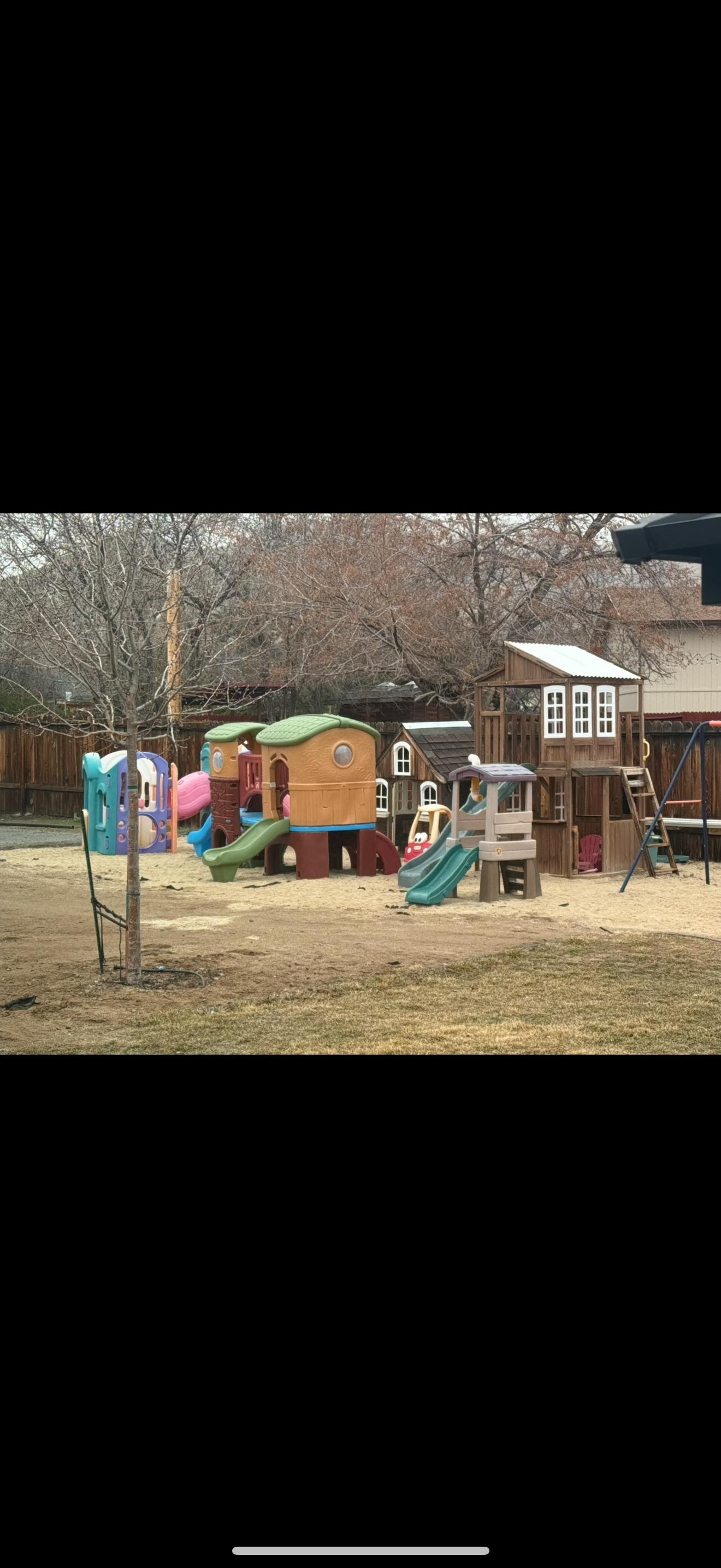 Outdoor playground with multiple playhouses and slides