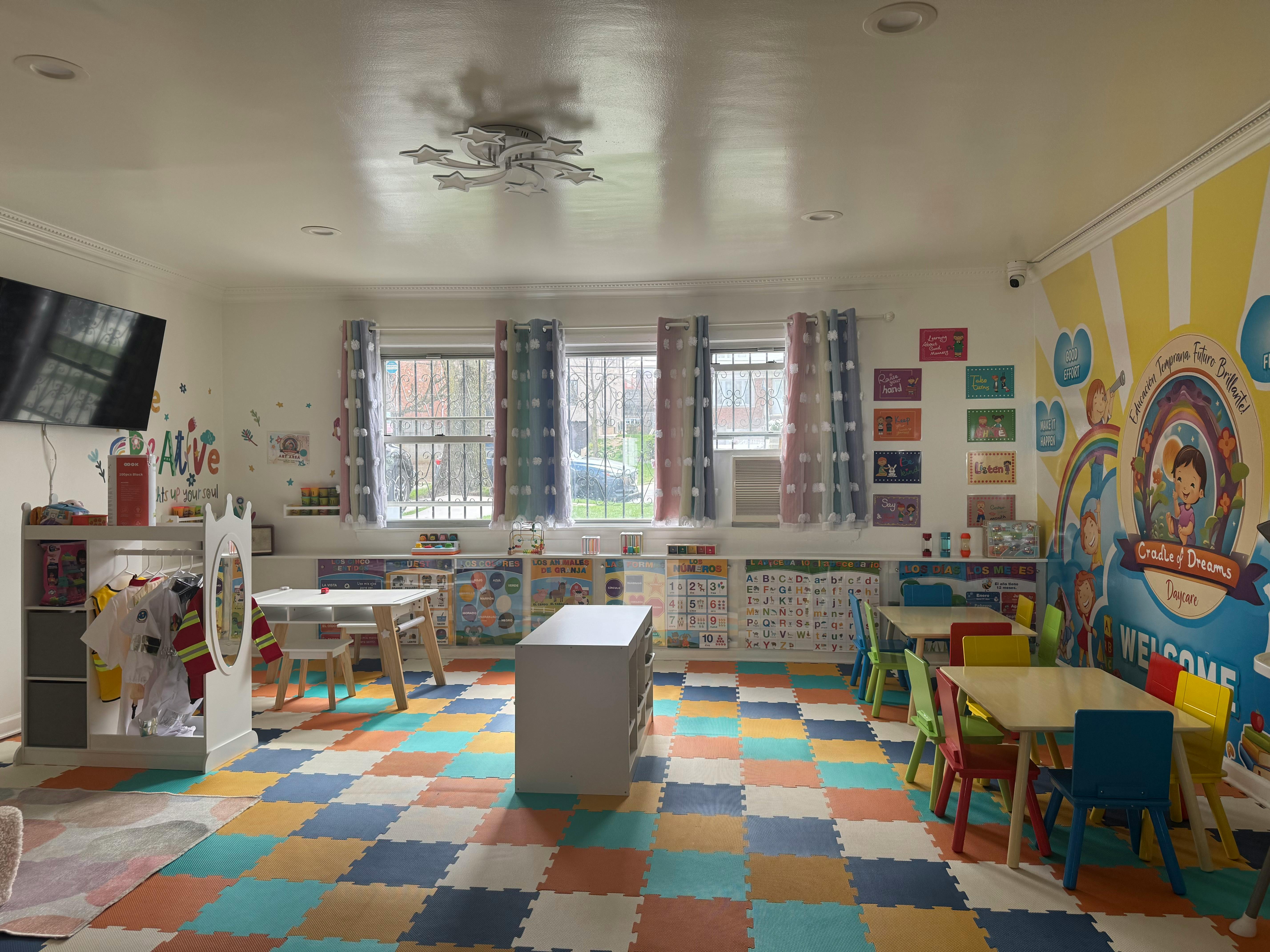Empty classroom with colorful floor tiles and small tables