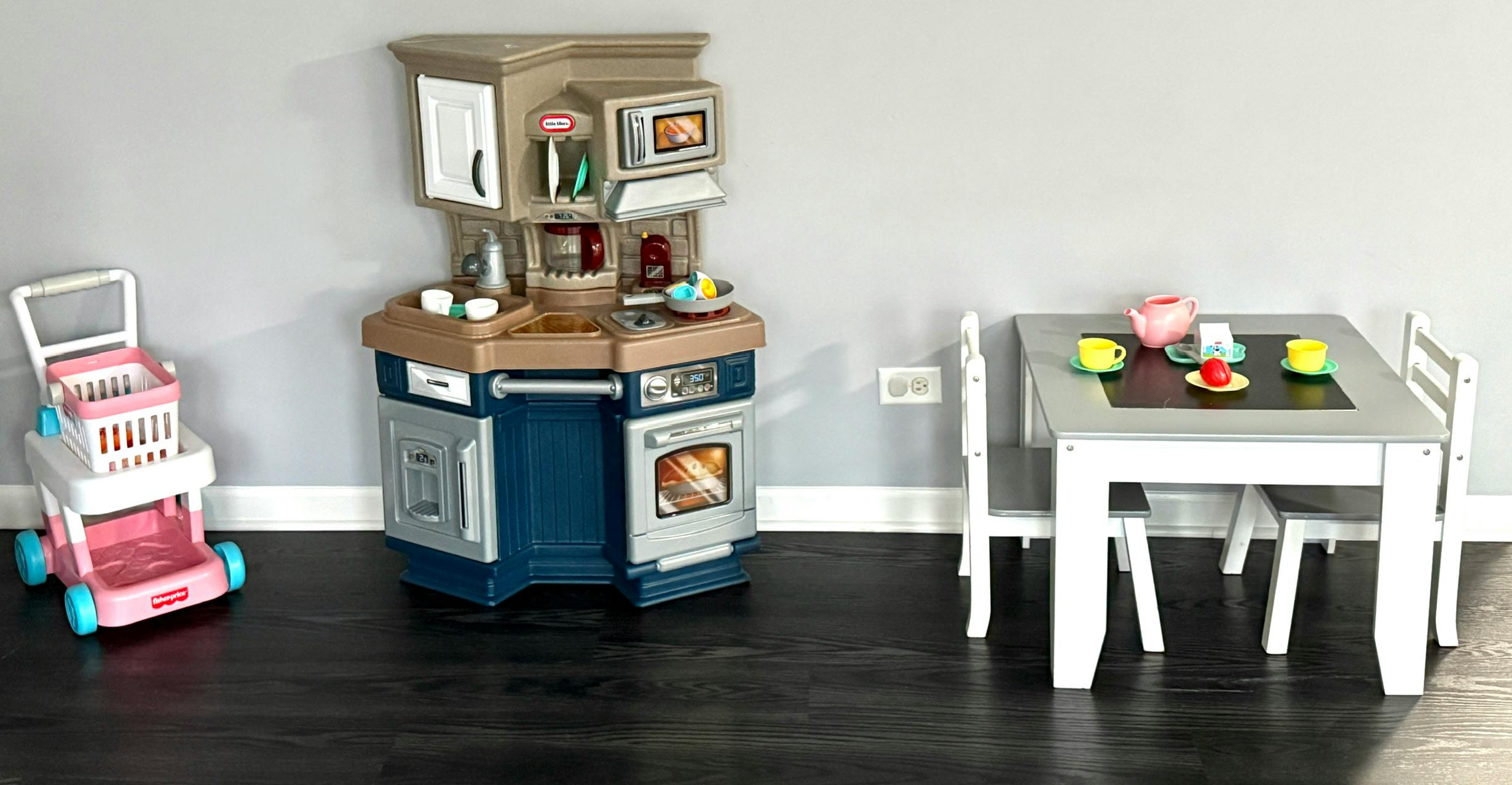 Play kitchen, shopping cart, and small table with chairs