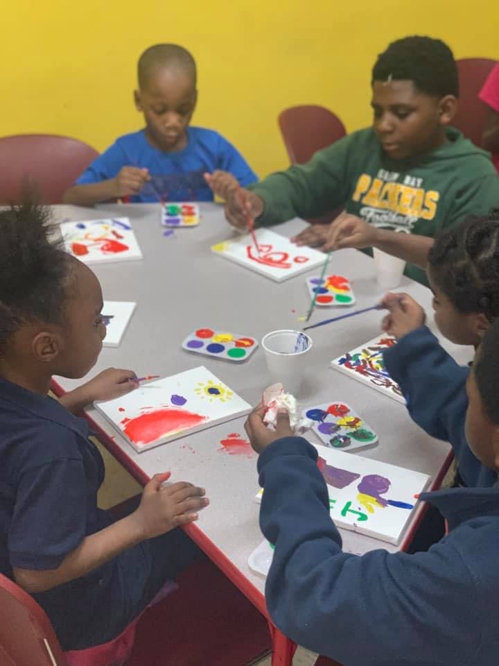 Children painting at a table