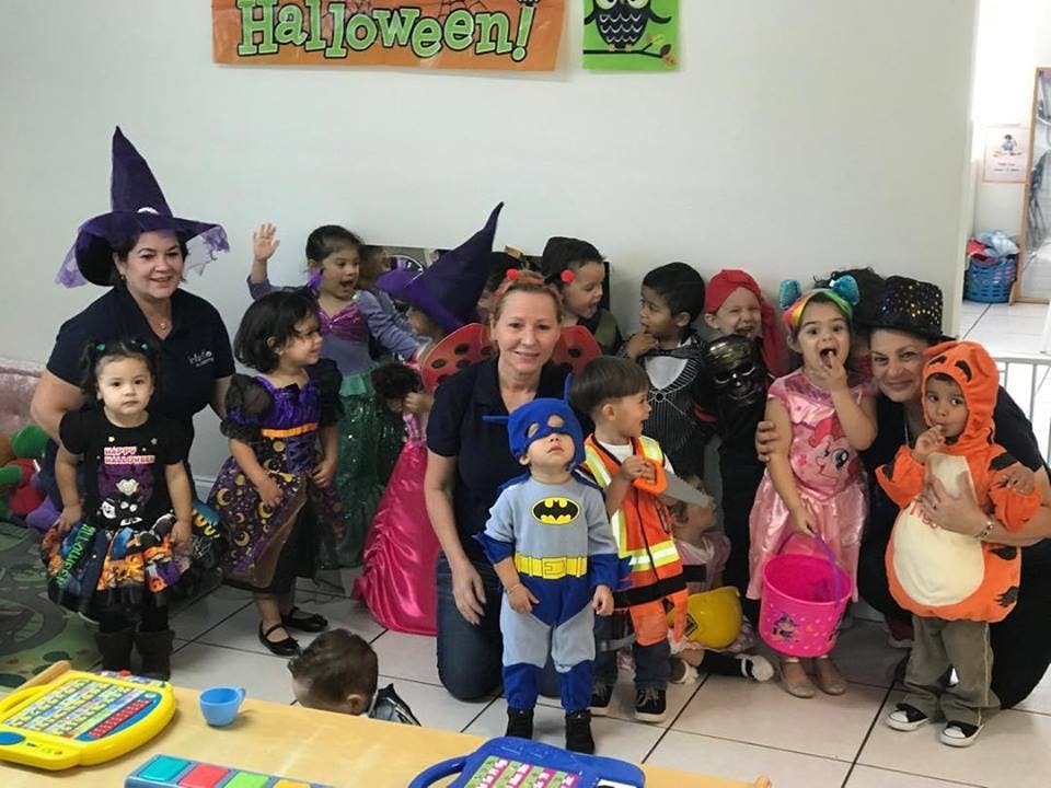 People and children in Halloween costumes