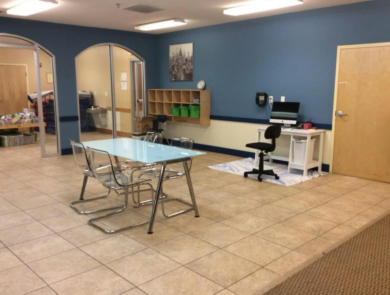 Room with a table and chairs, and a desk with a computer