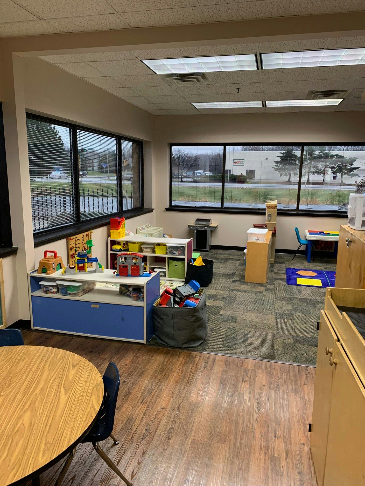 Classroom with toys, tables, and large windows