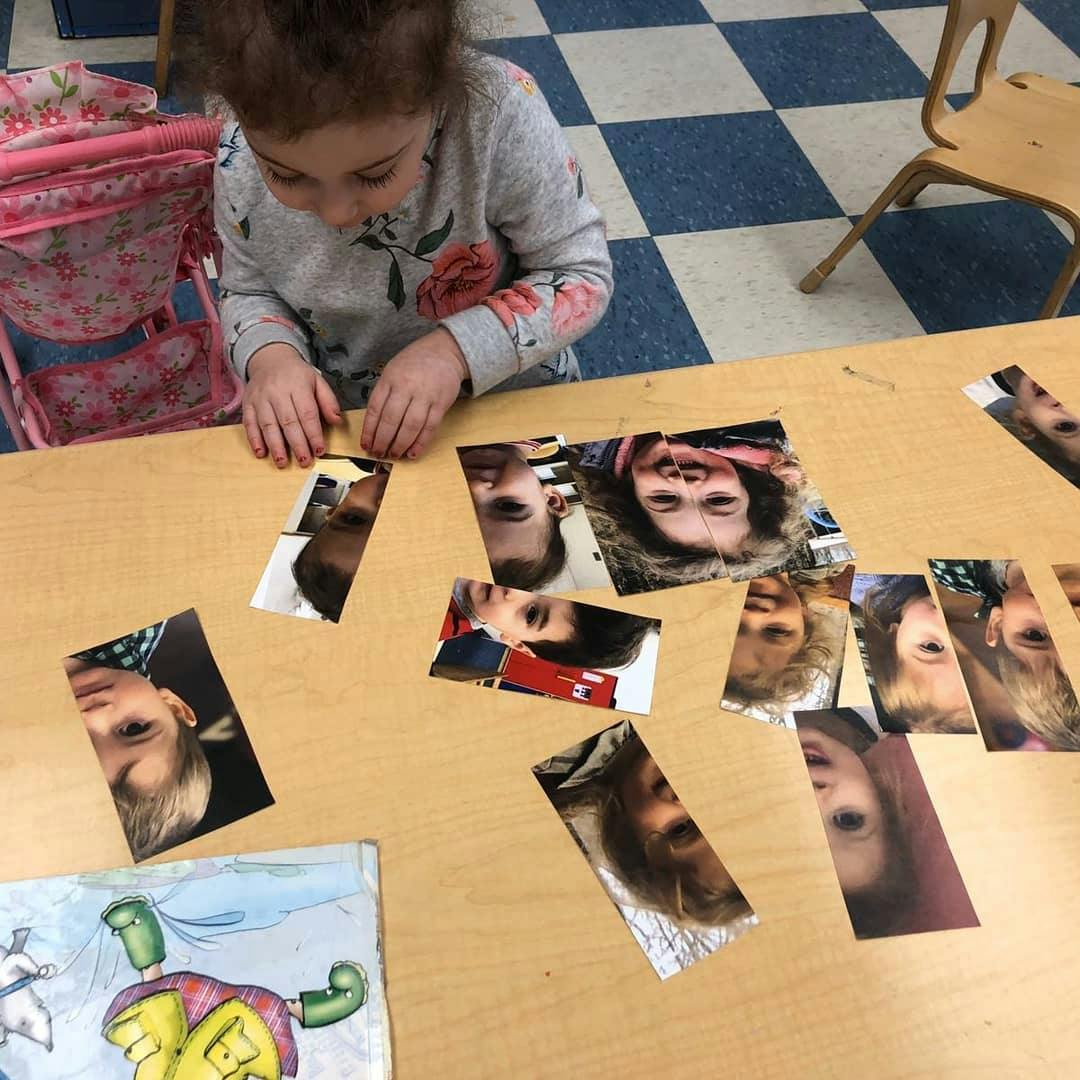 Child looking at photos on a table