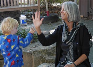 Adult and child high-fiving
