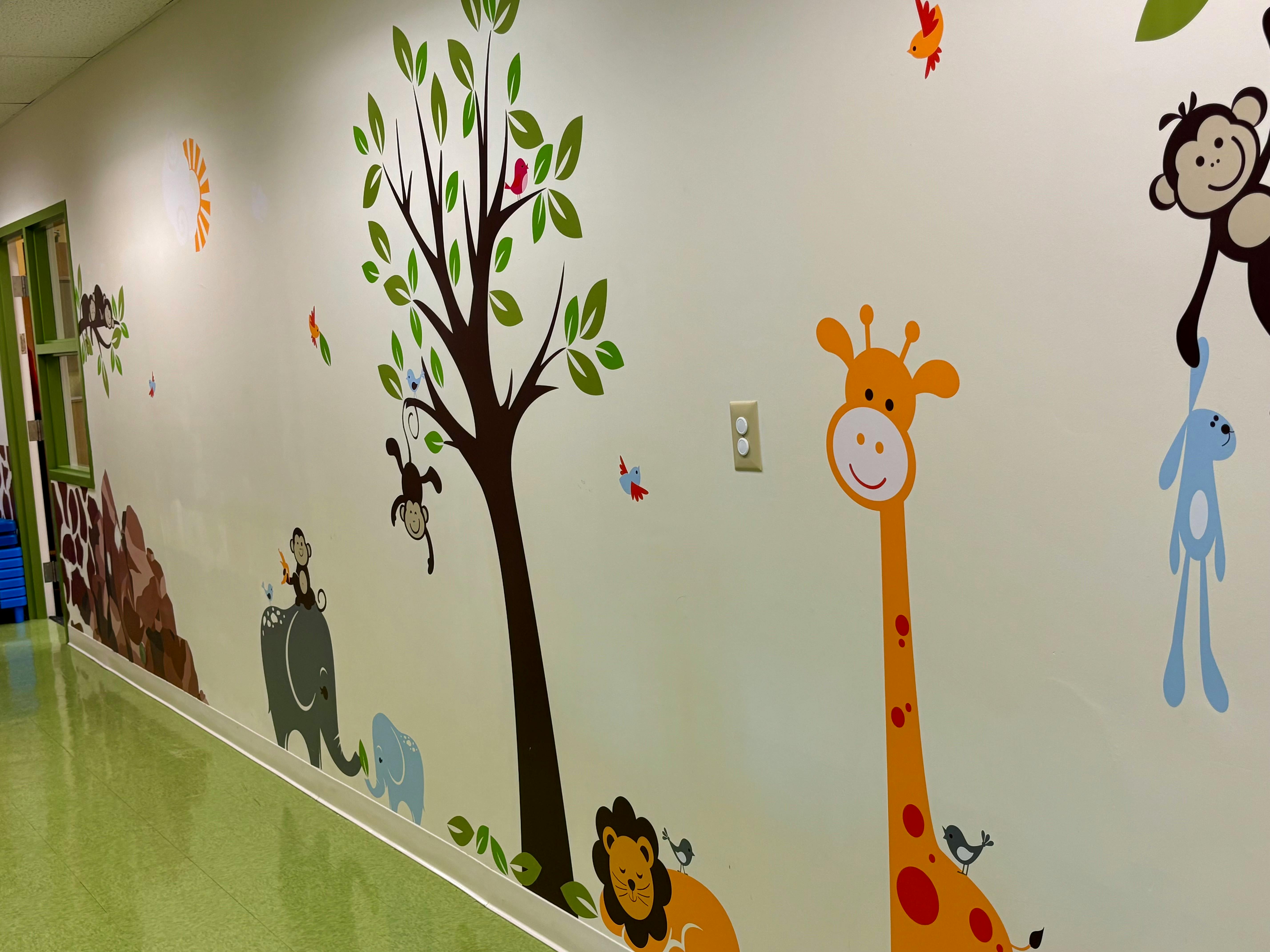 Wall decorated with cartoon animals and trees