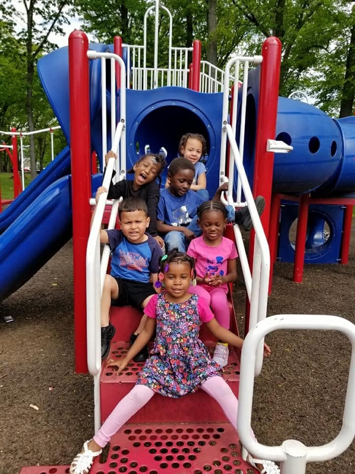 Group of children on a red and blue playground structure