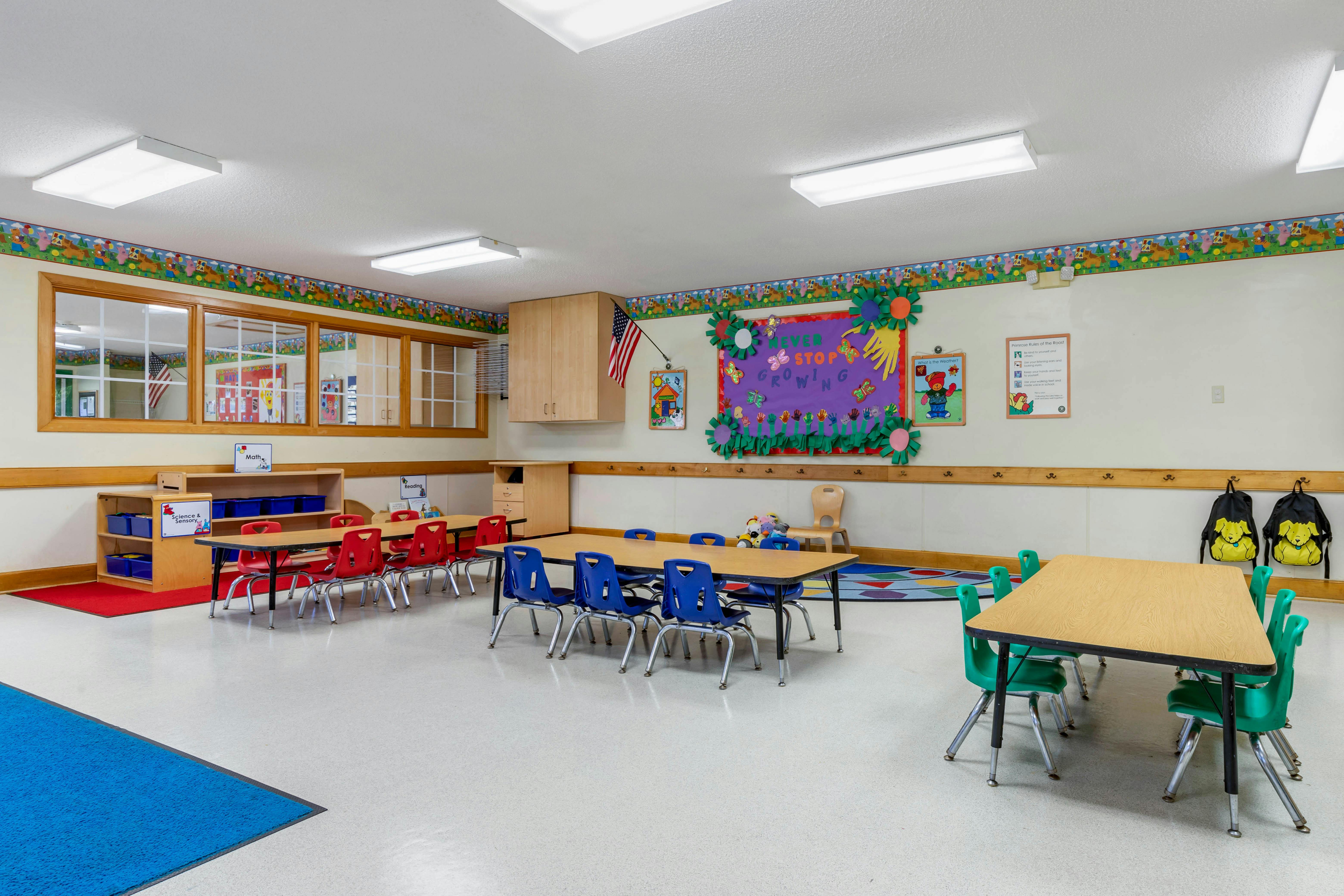 Classroom with small tables, chairs, and colorful decorations
