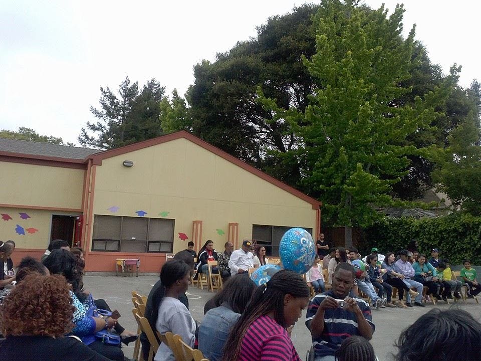 People sitting outdoors in front of a building
