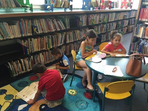 Children reading books in a library