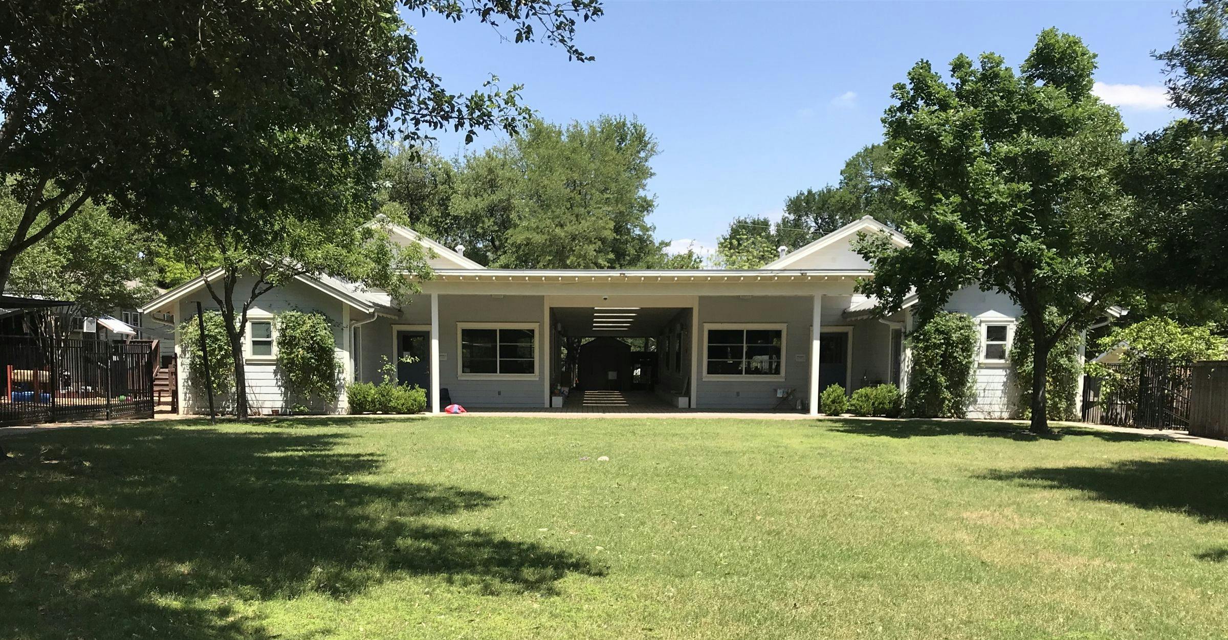 Building with a large grassy lawn in front