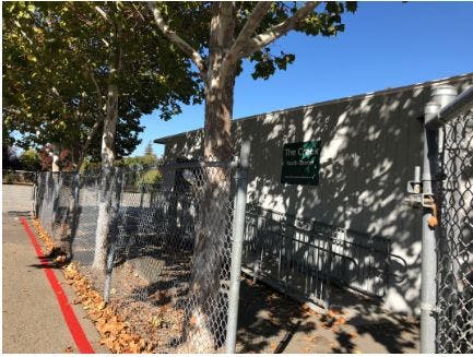 Chain link fence next to a building with a ramp