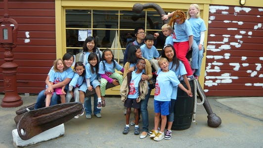 Group of adults and children posing outdoors