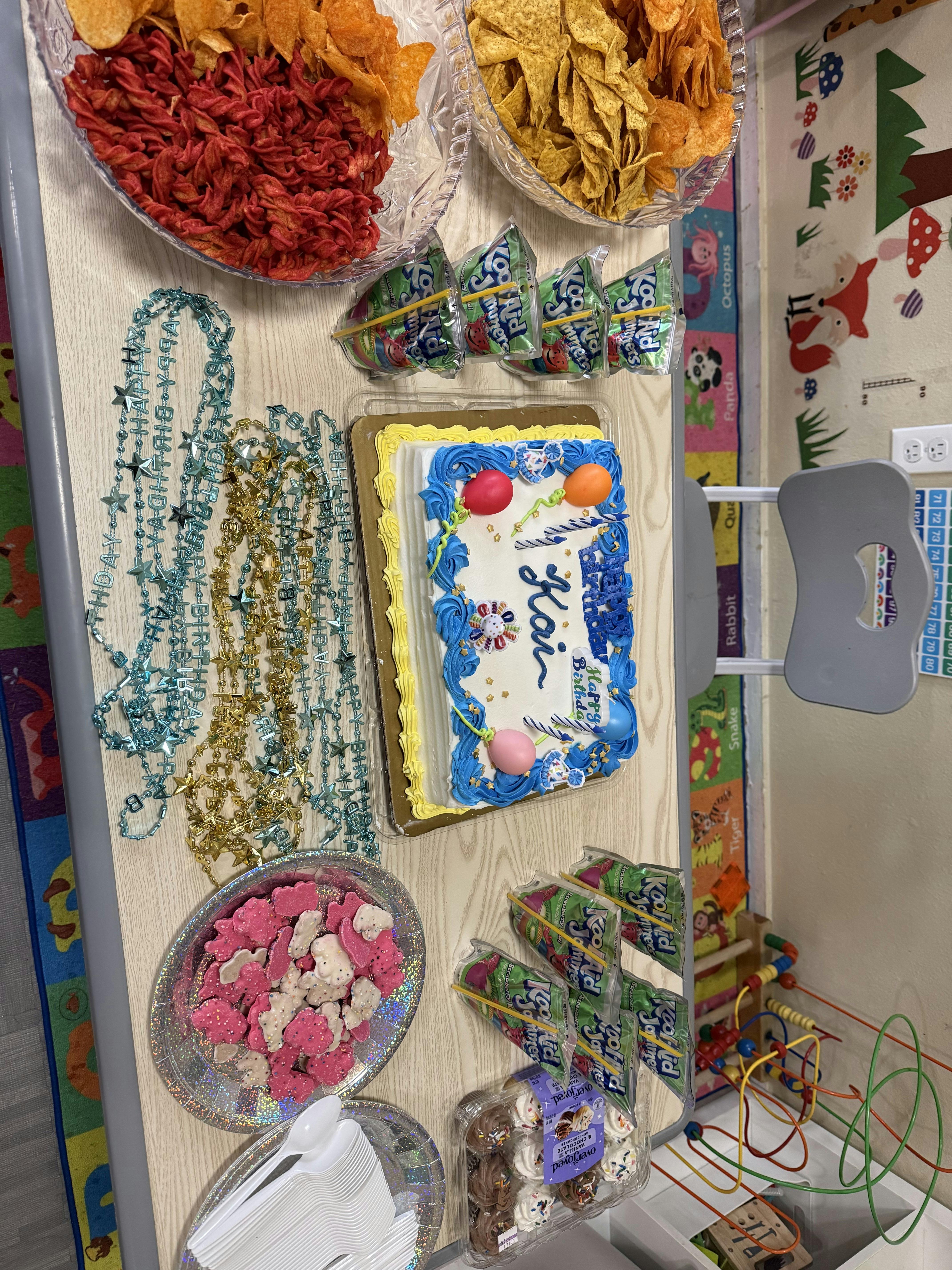 Birthday cake and snacks on a table