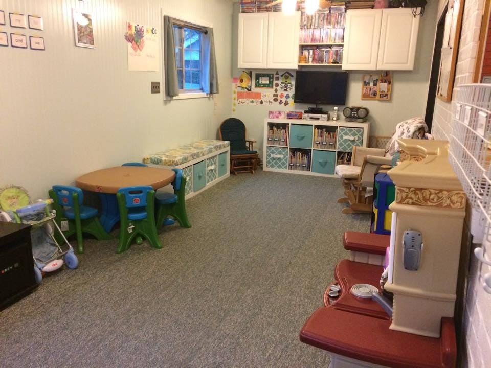 Playroom with small table and chairs, storage units, and a television